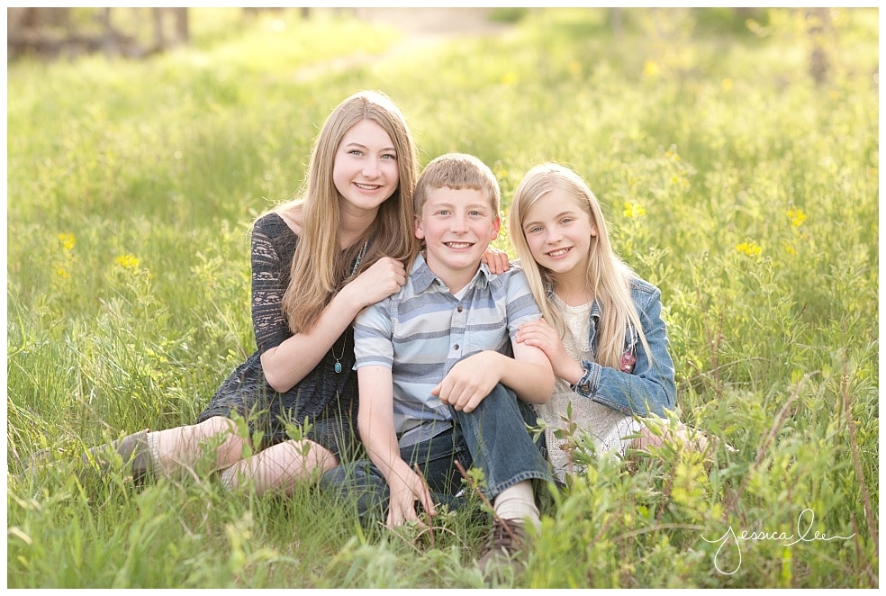 Boulder Family Photographer, three siblings together in green grass