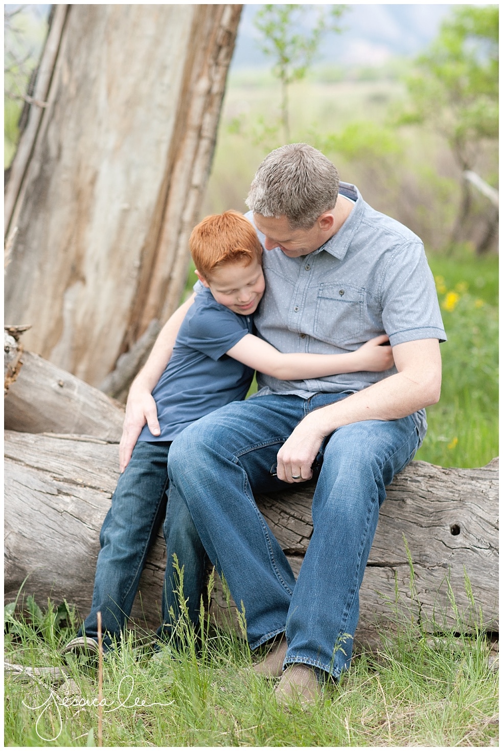 Family Photographer Boulder, dad and son hugging on log