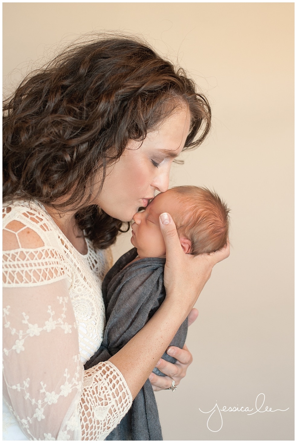 newborn photographer broomfield, mom kissing newborn forehead