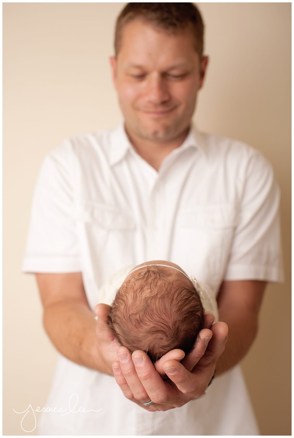 Baby Photography Boulder, dad holding baby head in hands