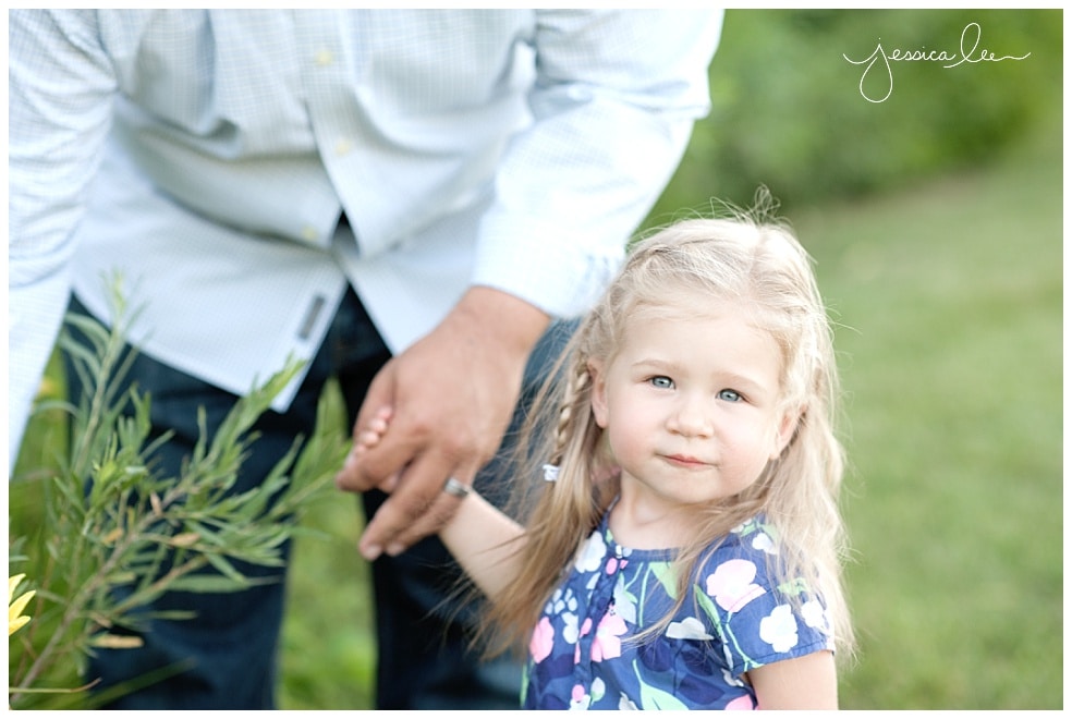 Family photographer longmont, dad with daughter picking flowers