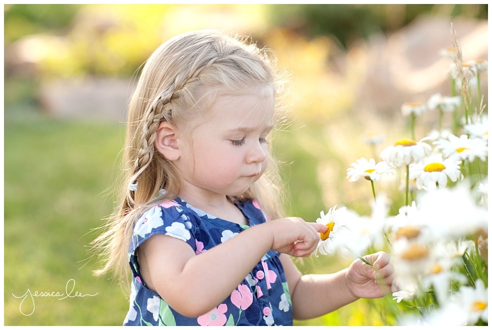 family photographer longmont, little girl pointing at flower