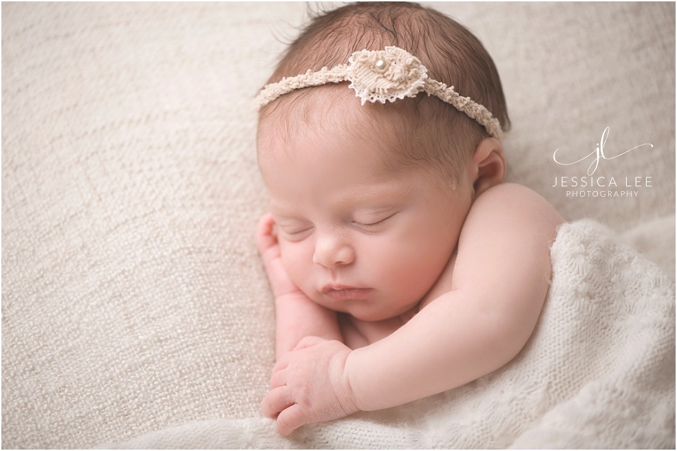 Baby Photographer Erie, newborn snuggling in blanket
