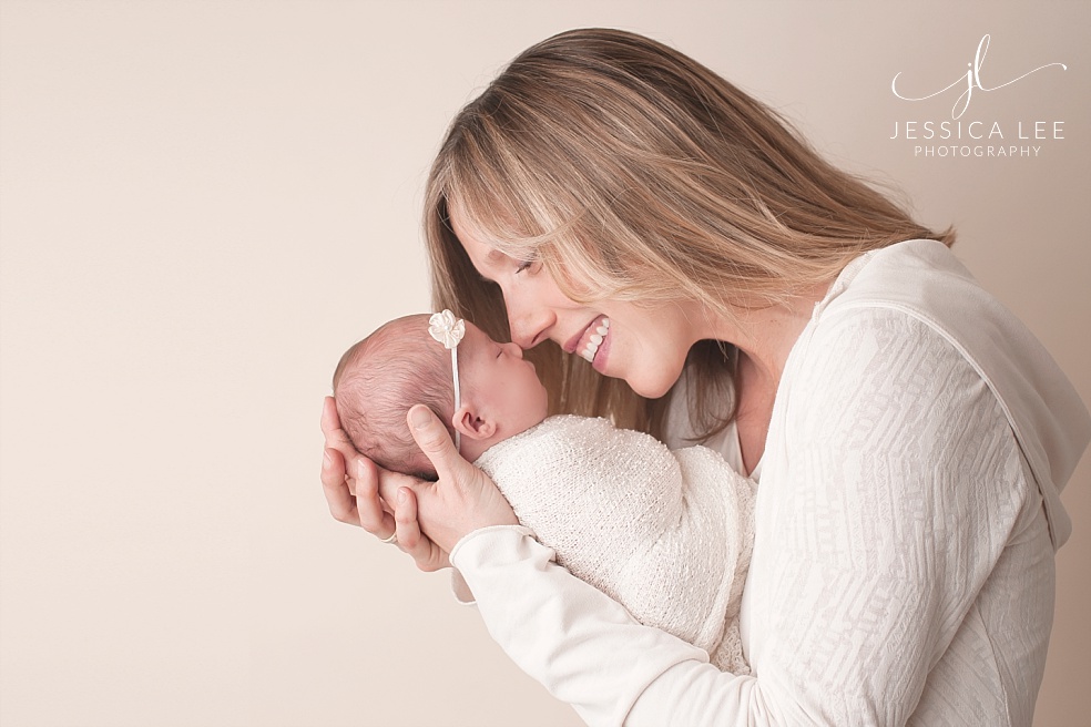 Broomfield Colorado Newborn Photographerm, mother snuggling nose to nose to baby