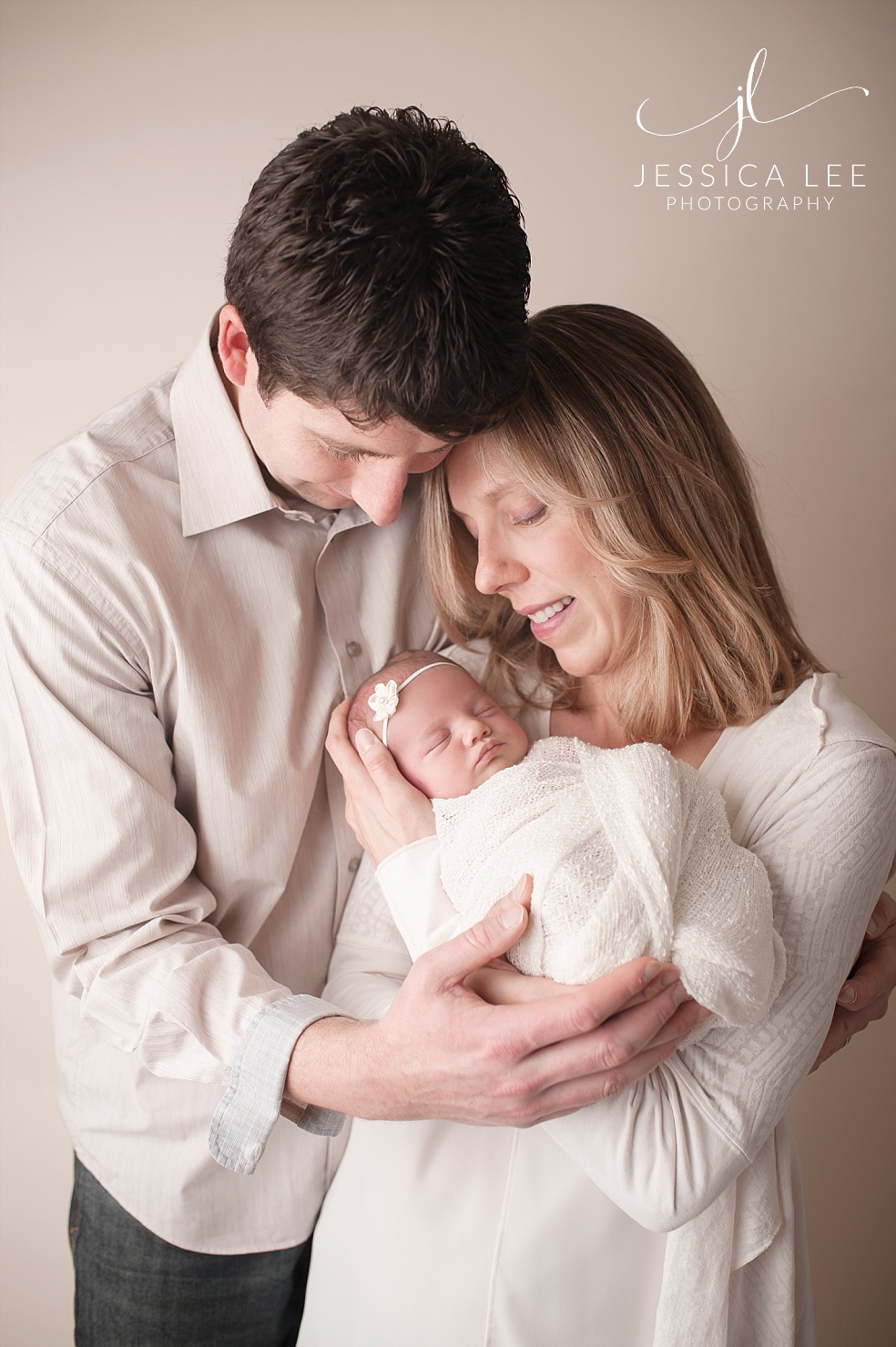 Broomfield Colorado Newborn Photographer, family of three cuddling together
