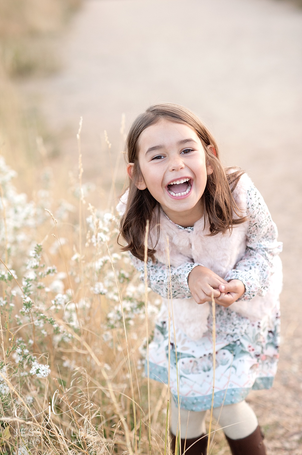 Broomfield Colorado Family Photographer, girl giggling in grass