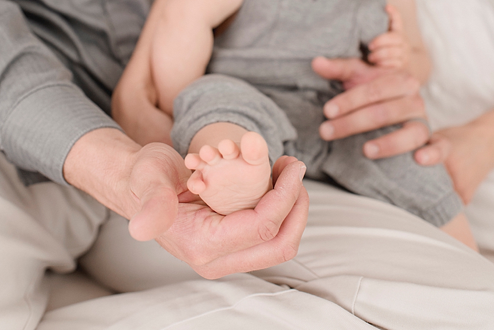 Detail photos of baby foot held by dad | Photo by Huntsville Baby Photographer Jessica Lee 