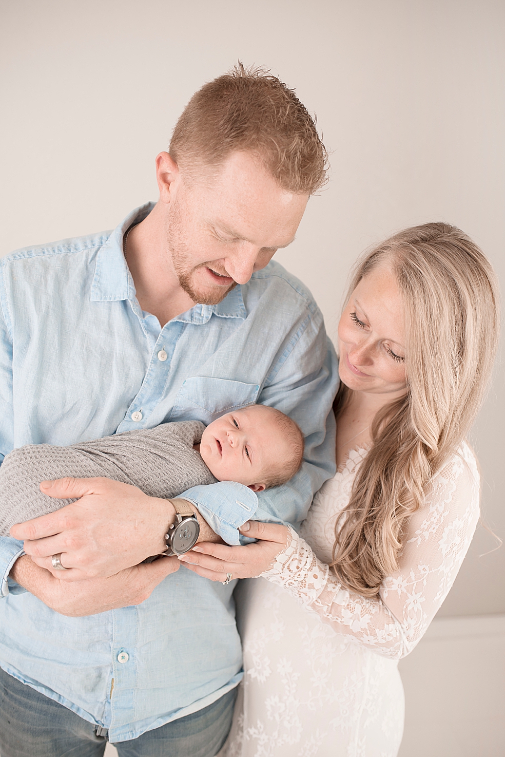 Mom and dad holding newborn baby boy | Photo by Jessica Lee Photography