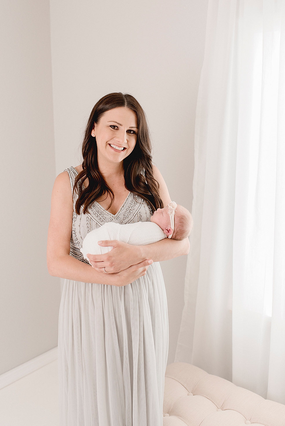 New mom in beaded gray dress smiling | Photo by Decatur Alabama Newborn Photographer Jessica Lee 