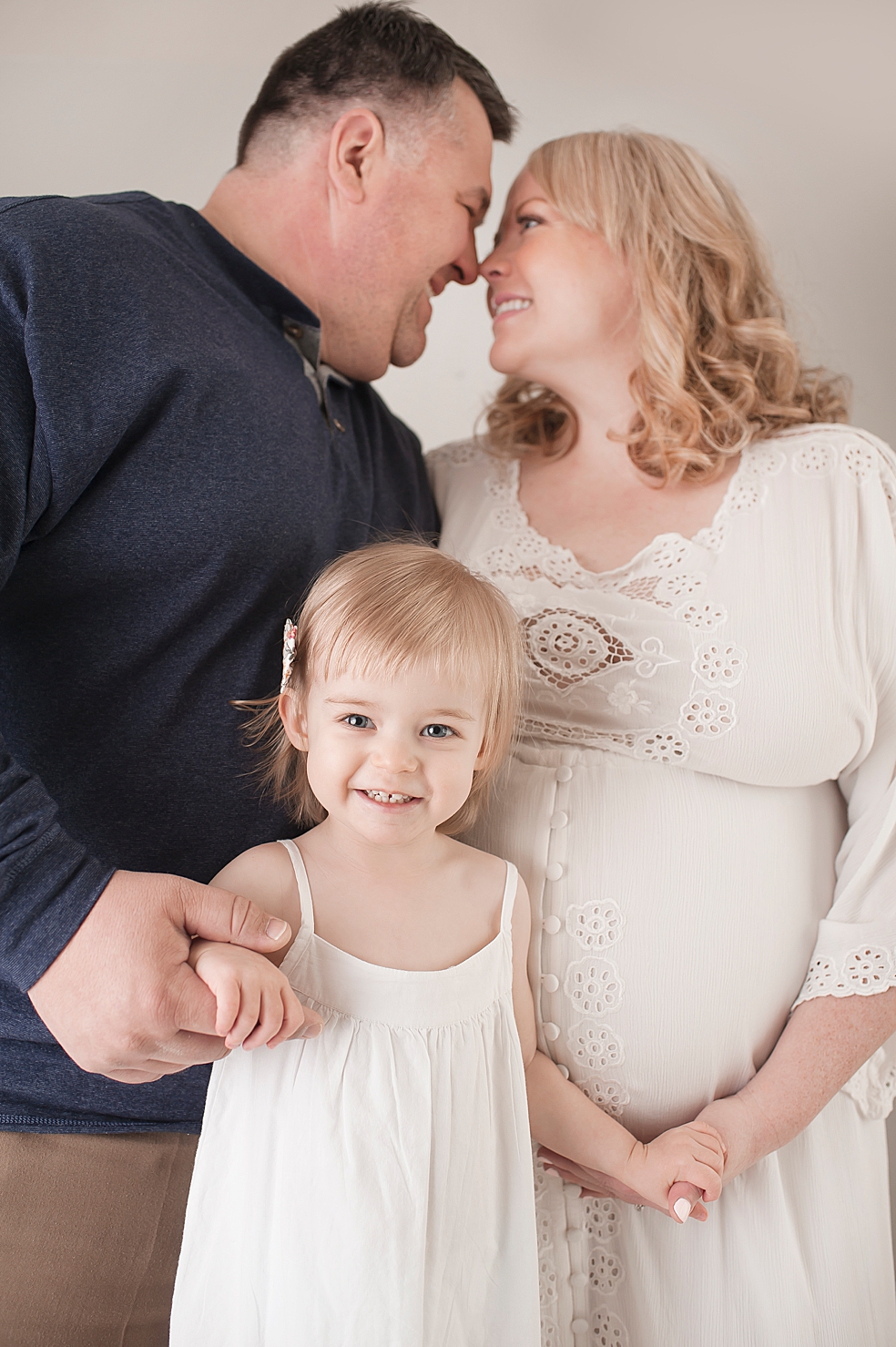 Detail of toddler girl in white with parents | Photo by Decatur Alabama Maternity Photographer Jessica Lee