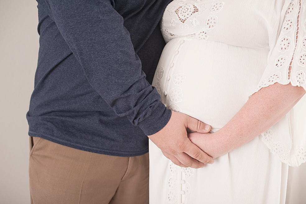 Detail image of mom and dad's hands on moms belly | Photo by Decatur Alabama Maternity Photographer Jessica Lee