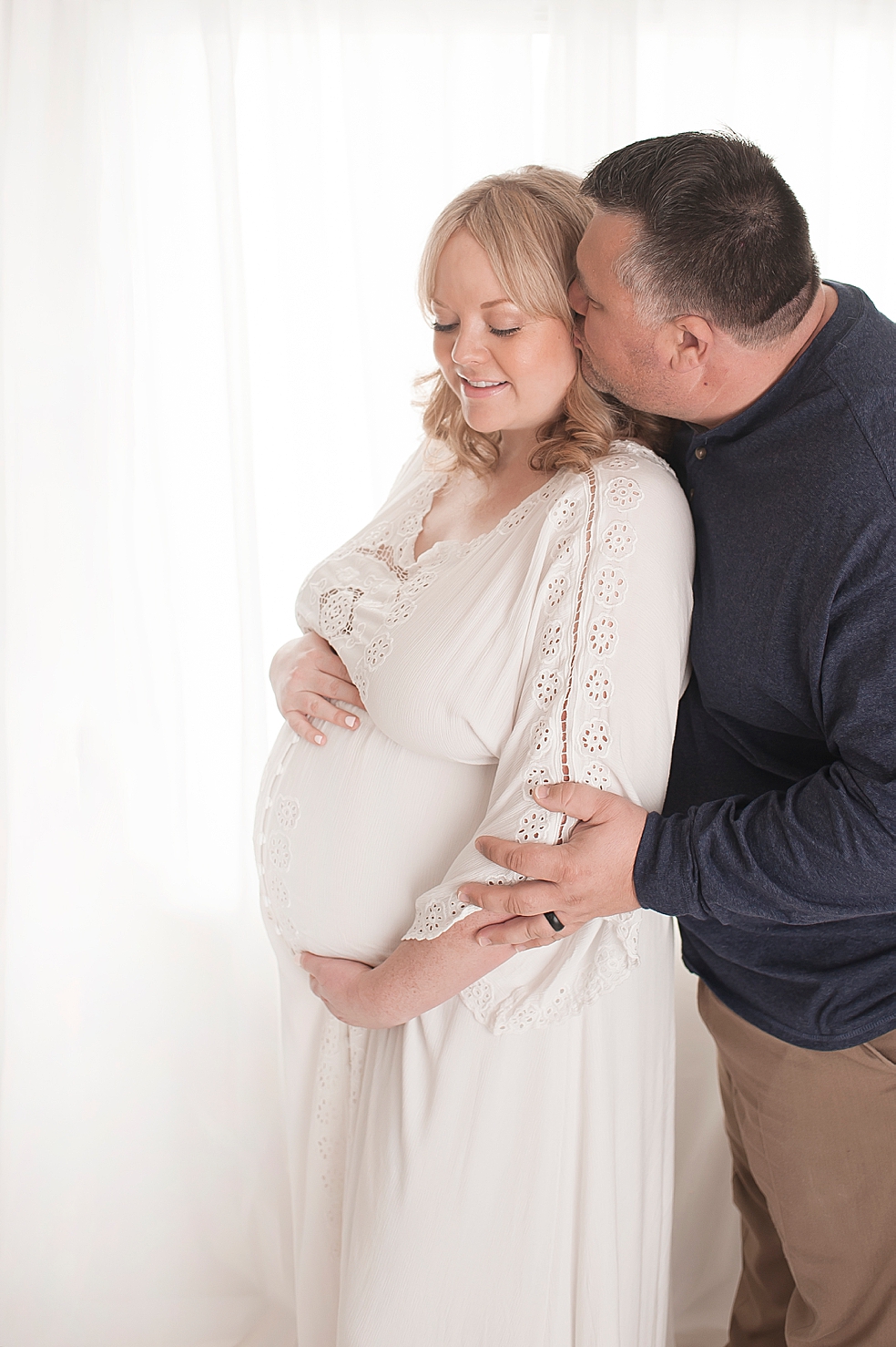 Mom and dad snuggling in the studio | Photo by Decatur Alabama Maternity Photographer Jessica Lee