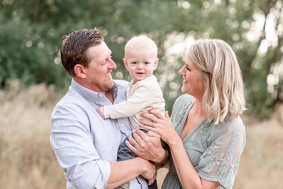 Mom and dad smiling a toddler baby boy | Photo by Madison Alabama Baby Photographer Jessica Lee