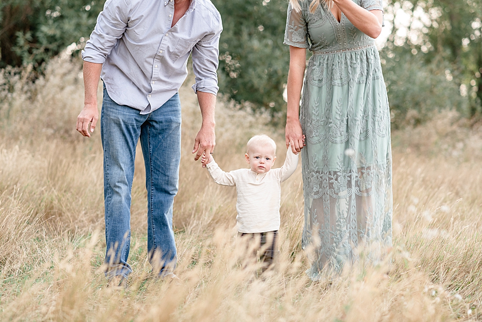 Mom and dad walking with toddler baby boy | Photo by Jessica Lee Photography 