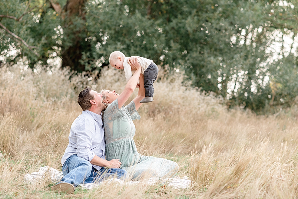 Family playing with their toddler in a field | Photo by Jessica Lee Photography 