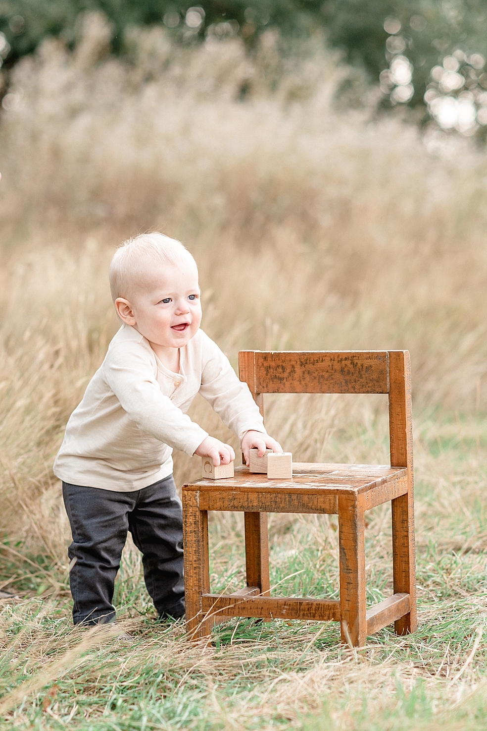 Toddler boy playing with blocks on a chair | Photo by Madison Alabama Baby Photographer Jessica Lee
