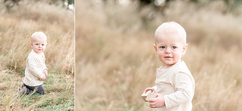 Little boy in cream shirt sitting in a field | Photo by Jessica Lee Photography 