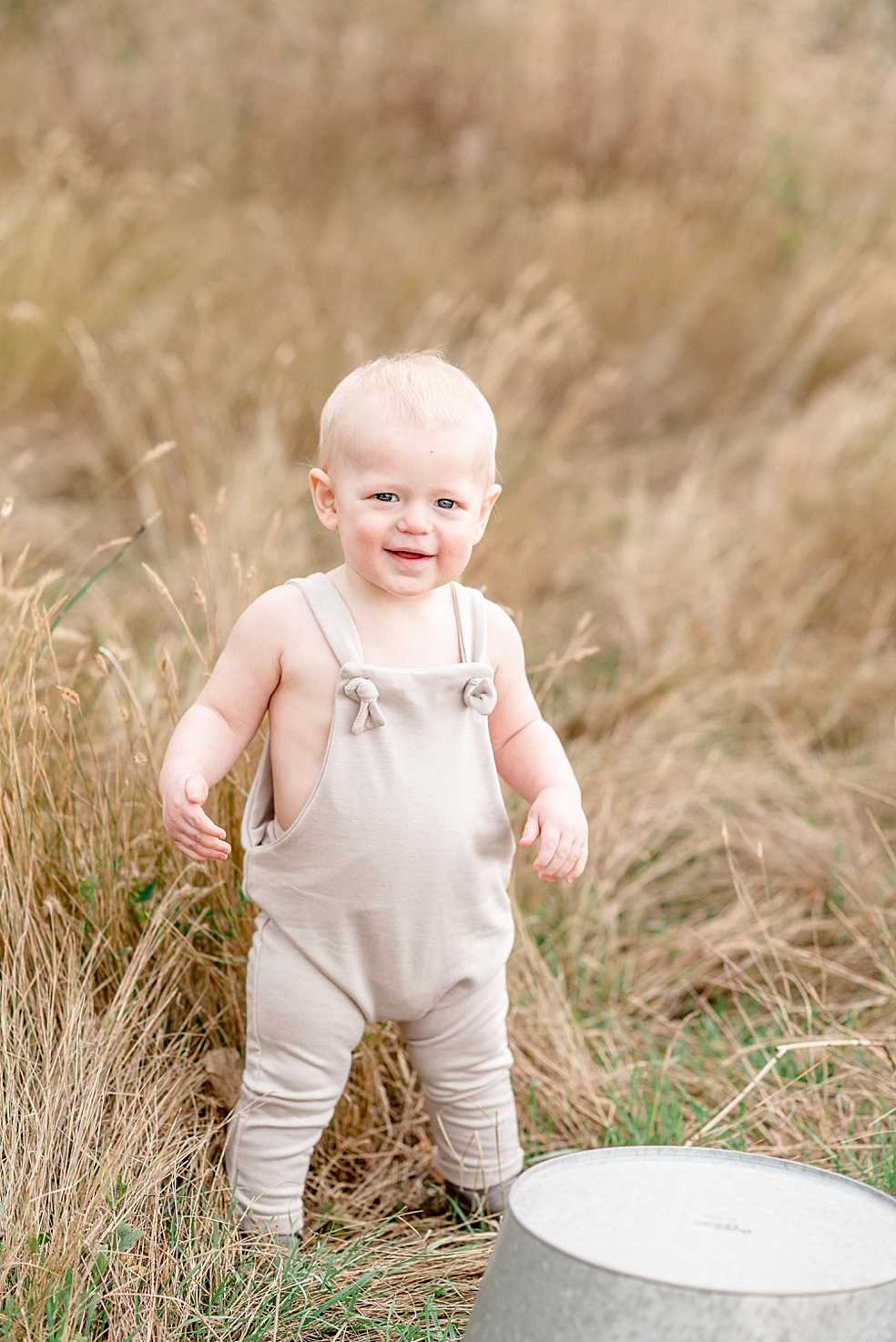 Smiling toddler boy in a field | Photo by Jessica Lee Photography 