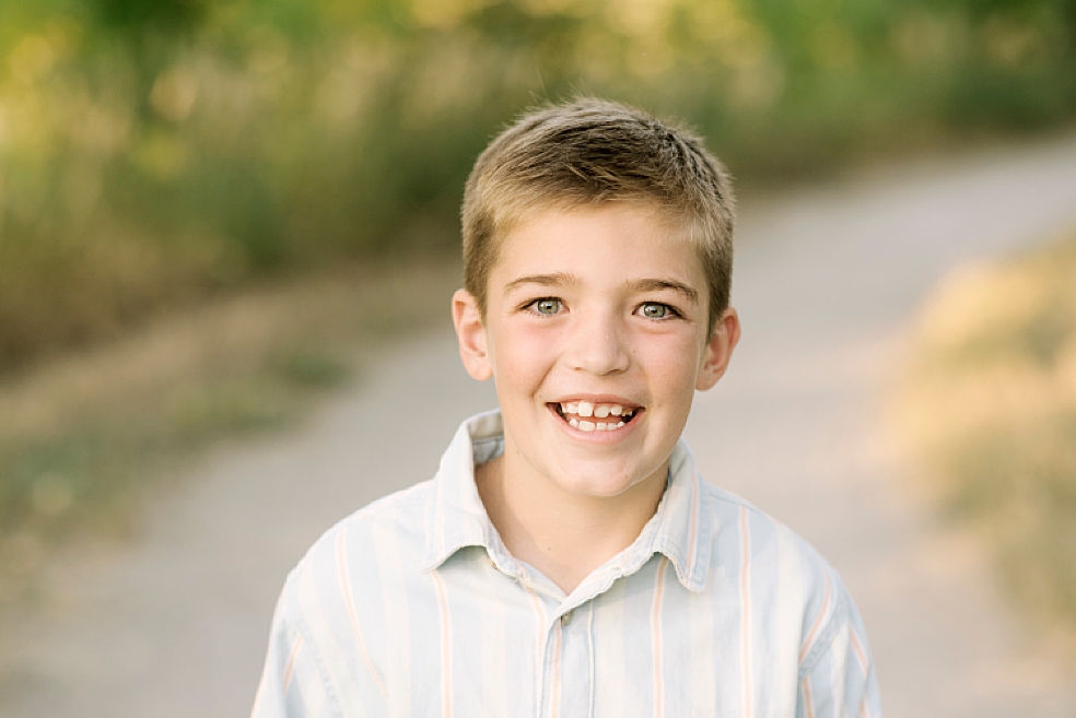 Young boy smiling in a blue button down | Photo by Jessica Lee Photography 