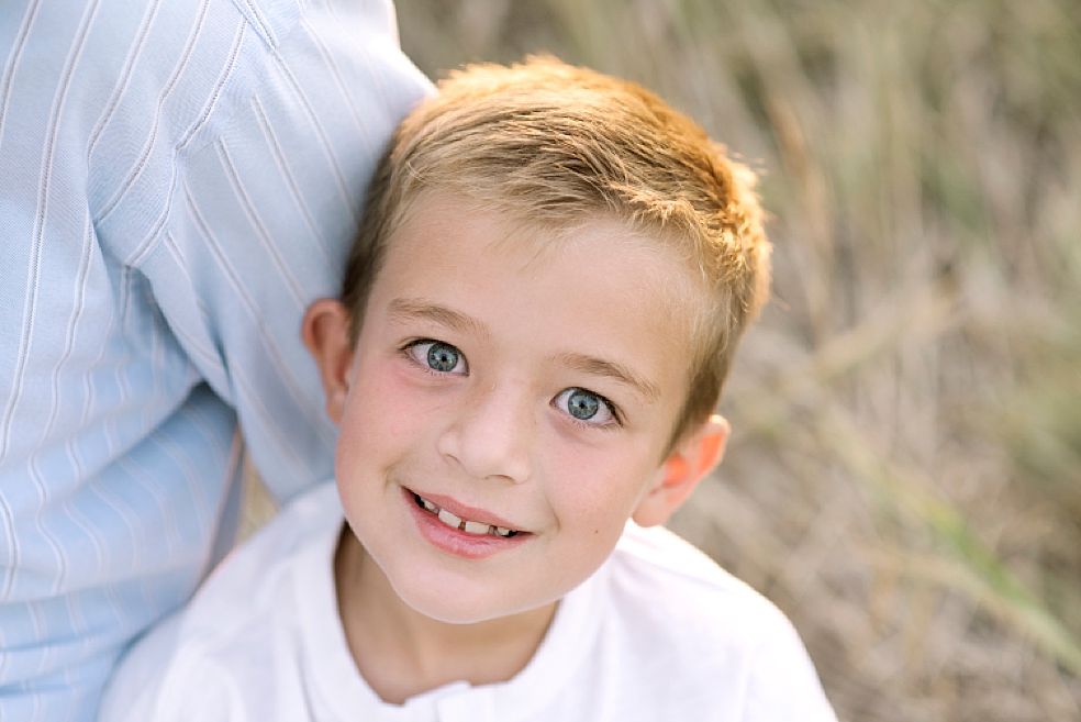 Little boy smiling in a white shirt | Photo by Jessica Lee Photography 