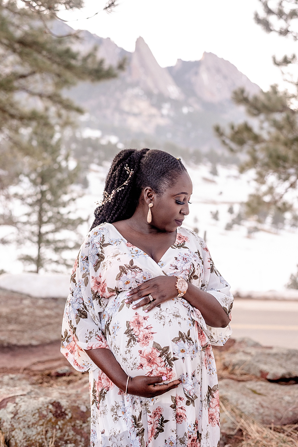 Mom to be in floral dress looking down her shoulder | Photo by Huntsville Motherhood Photographer Jessica Lee Photography