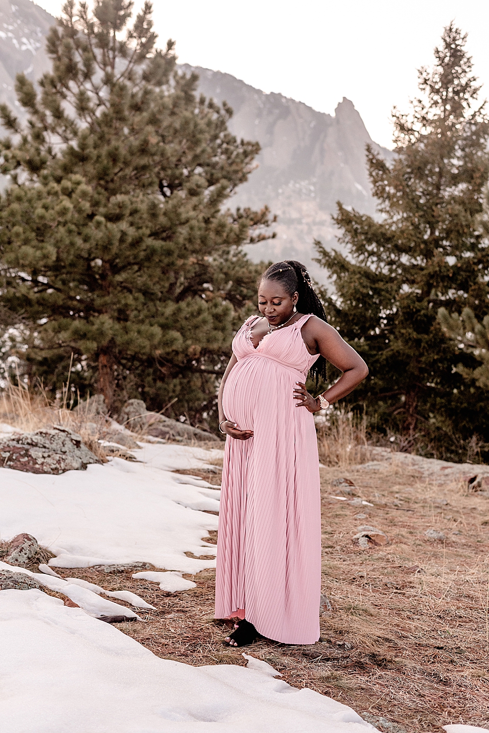 Mom to be in pink dress holding her belly | Photo by Jessica Lee Photography