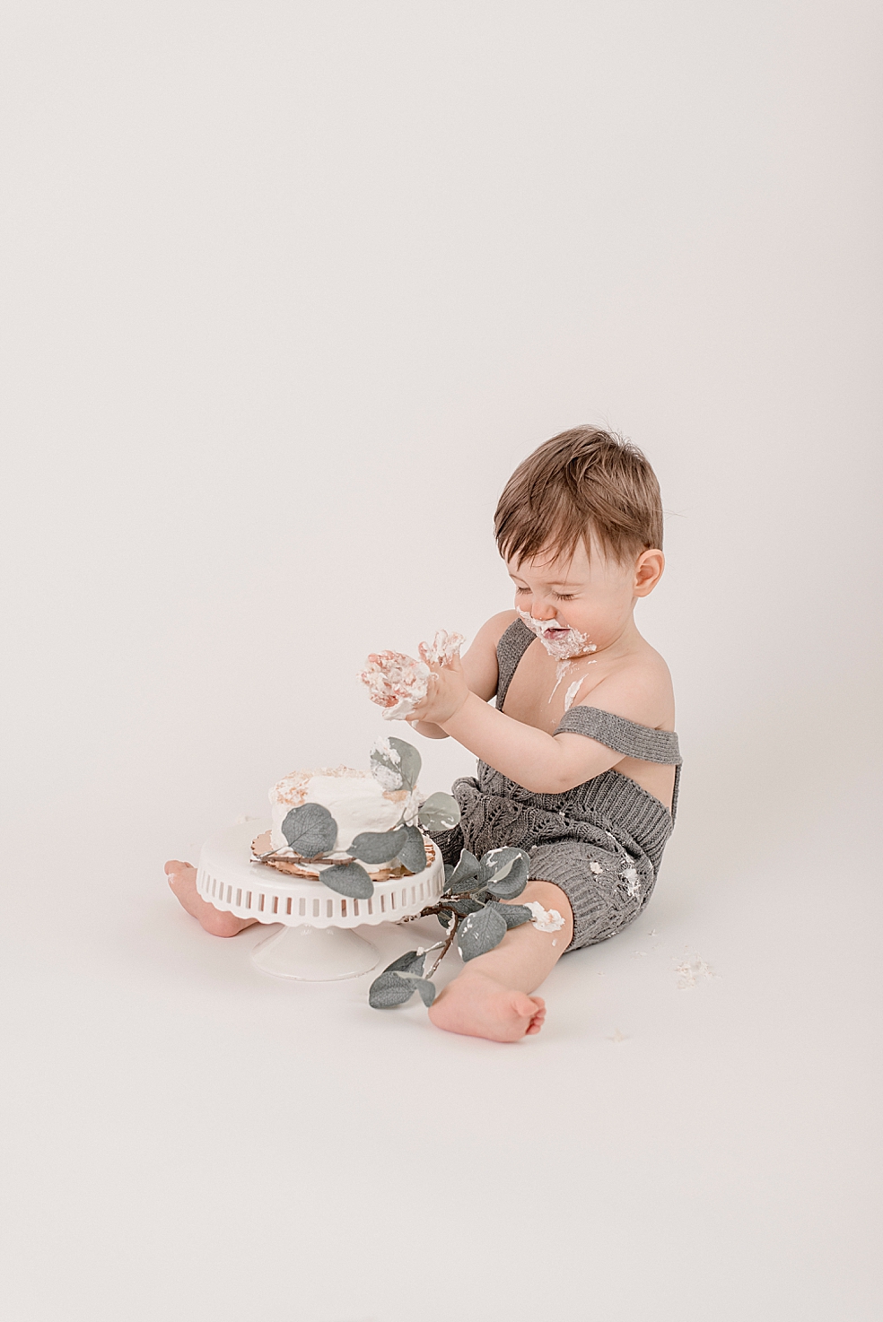 Baby boy playing with his smash cake | Photo by baby photographer South Huntsville Jessica Lee