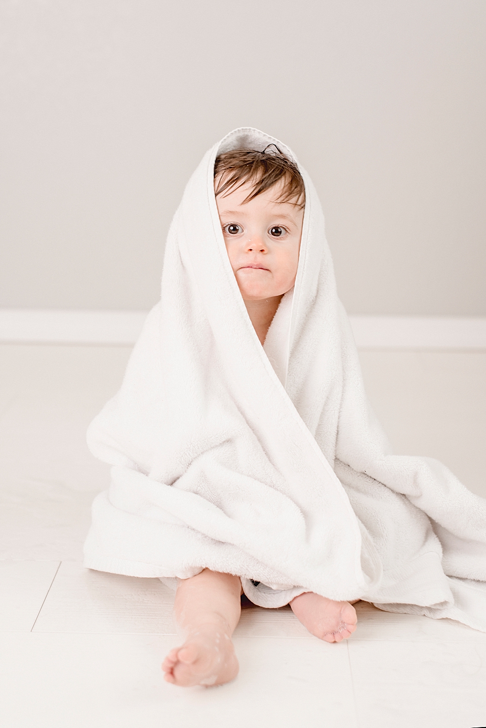 Baby boy wrapped in a towel | Photo by baby photographer South Huntsville Jessica Lee