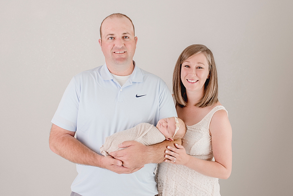 Mom and dad holding their newborn baby girl | Photo by Meridianville Newborn Photographer Jessica Lee