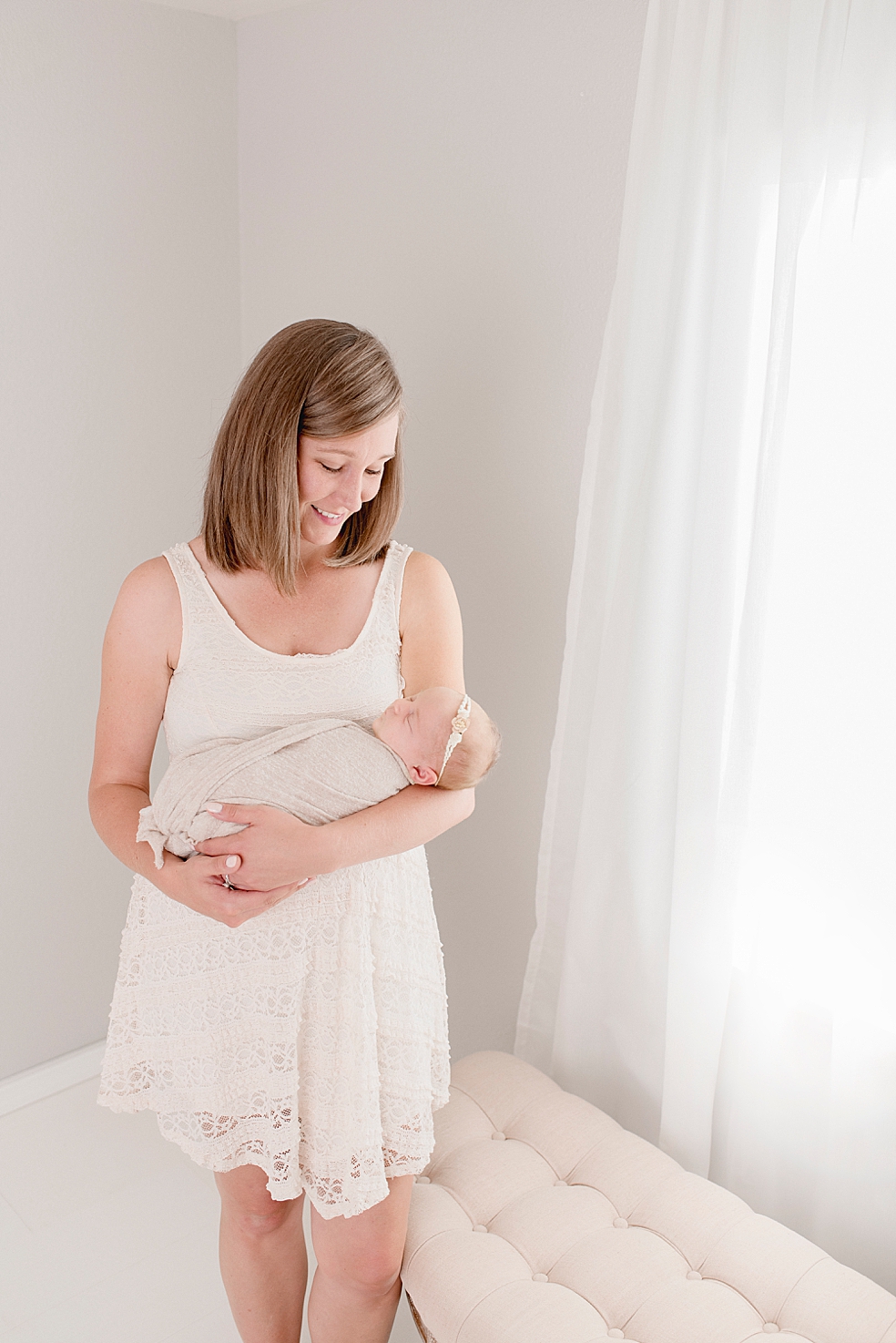 Mom smiling down at her new baby girl | Photo by Jessica Lee Photography