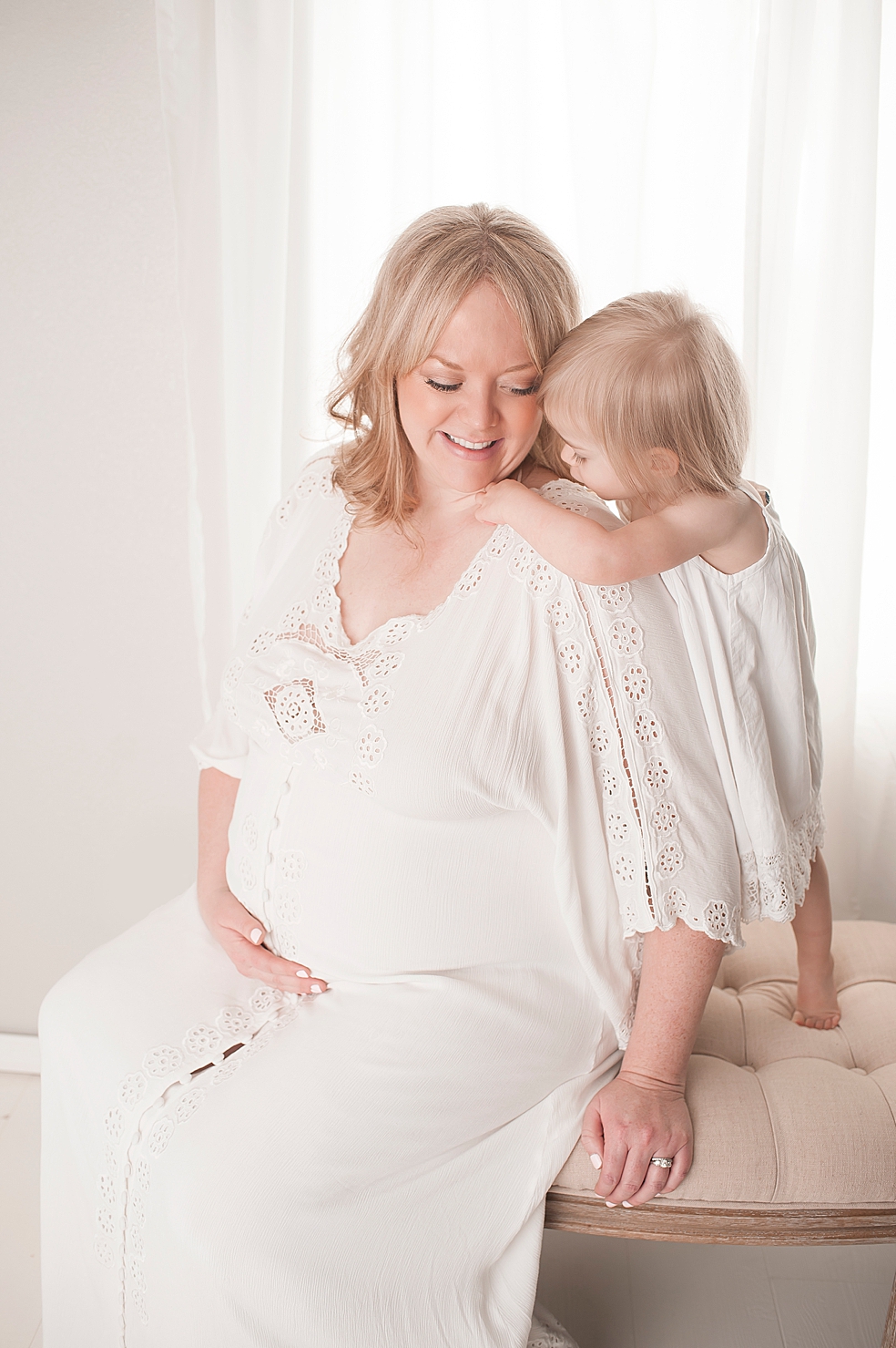 Mom in a long white dress with her little girl in white | Photo by Jessica Lee Photography