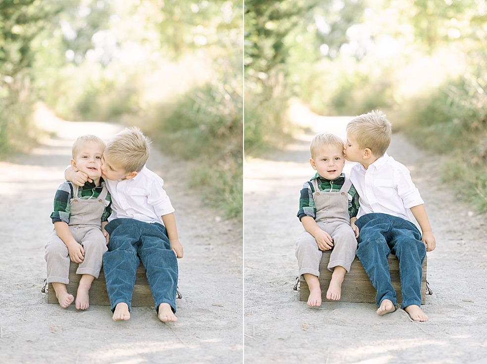 Little boys snuggling sitting on a box | Photo by Jessica Lee Photography