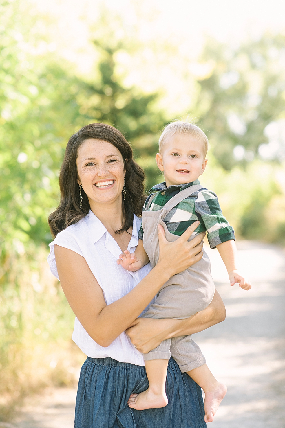 Mom and little boy in plaid smiling during family session in Meridianville AL | Photo by Jessica Lee Photography