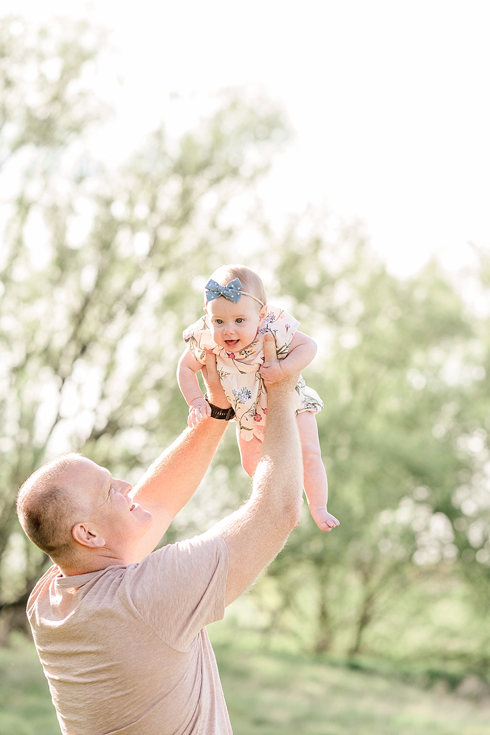Dad playing airplane with his baby girl | Photo by Jessica Lee Photography