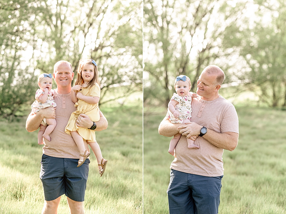 Dad holding his two daughters in a field | Photo by Jessica Lee Photography