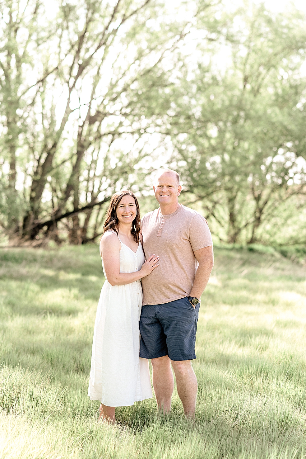 Mom and dad standing in a field | Photo by Light and Airy Alabama Photographer Jessica Lee 