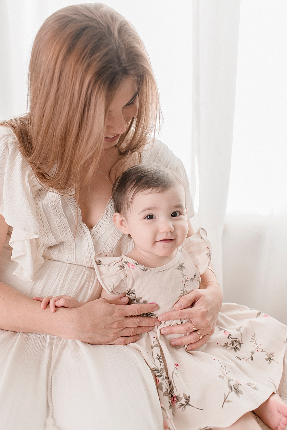 Baby girl and mom snuggling during her light and airy studio session | Photo by Jessica Lee Photography