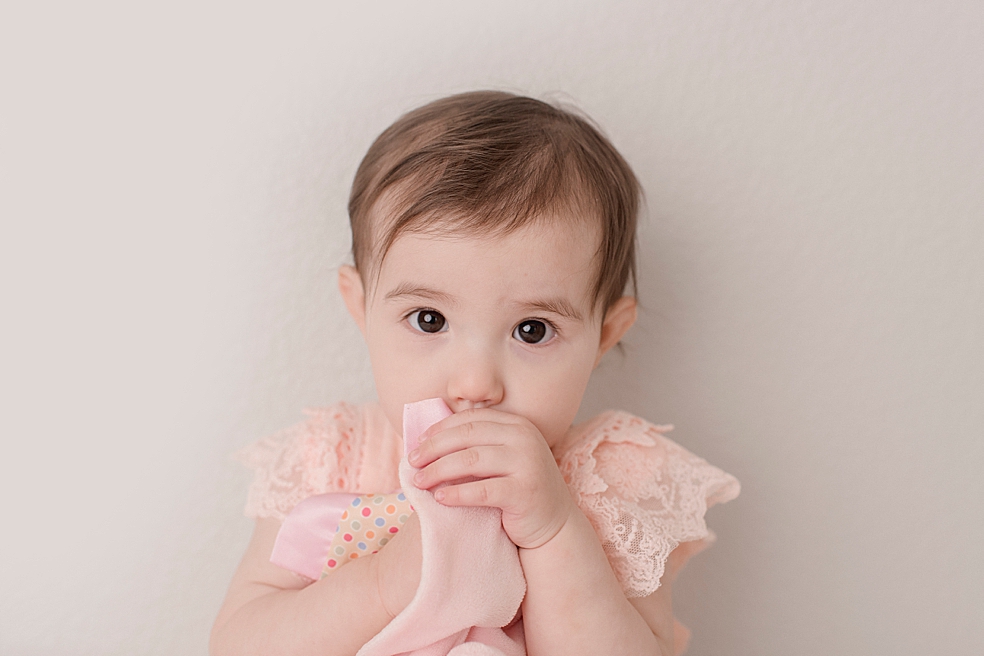 Baby girl with her lovie during her light and airy studio session | Photo by Jessica Lee Photography