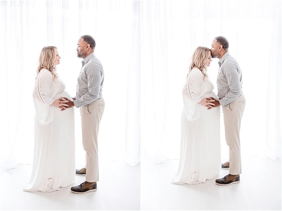 Woman and man with white backdrop kissing forehead, Timeless Studio Maternity Session, Jessica Lee Photography