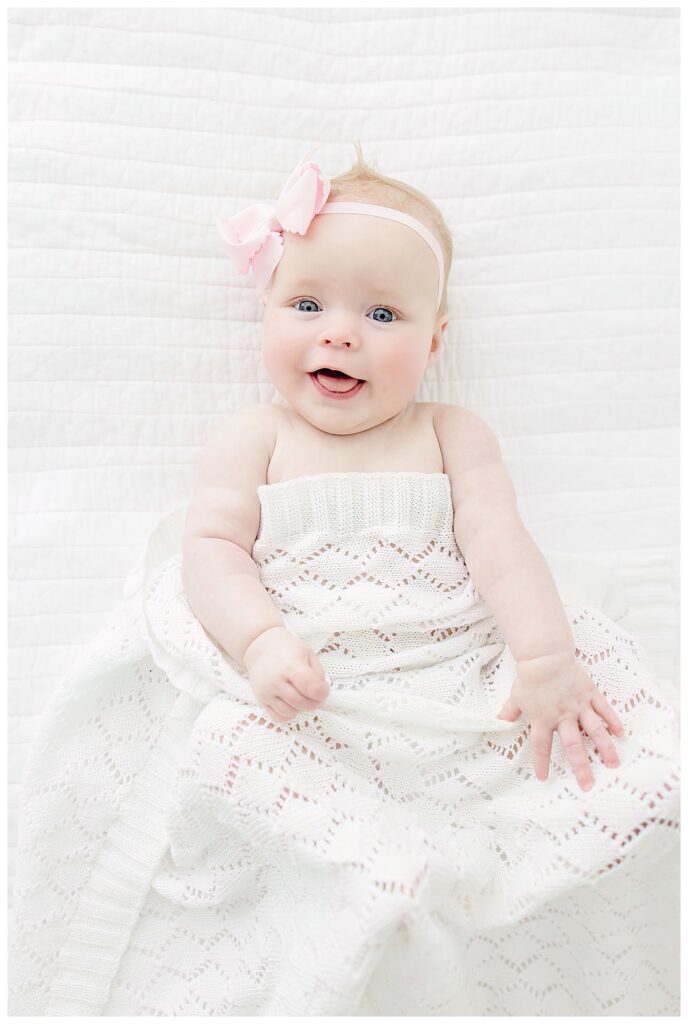 best baby photographer huntsville | baby with pink bow with white blanket